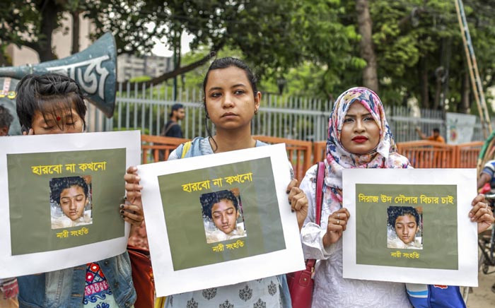 In this photo taken on 12 April 2019 Bangladeshi women hold placards and photographs of schoolgirl Nusrat Jahan Rafi at a protest in Dhaka, following her murder by being set on fire after she had reported a sexual assault. Picture: AFP.