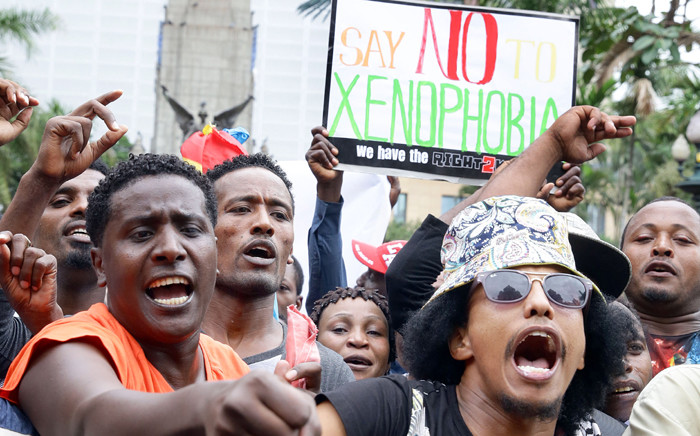 Demonstrators take part in an anti-xenophobic march outside the City Hall of Durban on 8 April, 2015. Hundreds of people marched today to protest against anti-immigrant violence, a week after hundreds were attacked near the eastern city of Durban. Picture: AFP.