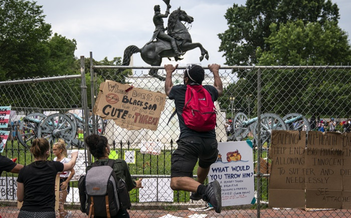 Protesters pull down a fence surrounding the statue of Andrew Jackson in an attempt to pull the statue down in Lafayette Square near the White House on 22 June 2020 in Washington, DC. Protests continue around the country over police brutality, racial injustice, and the deaths of African Americans while in police custody.  Picture: AFP.
