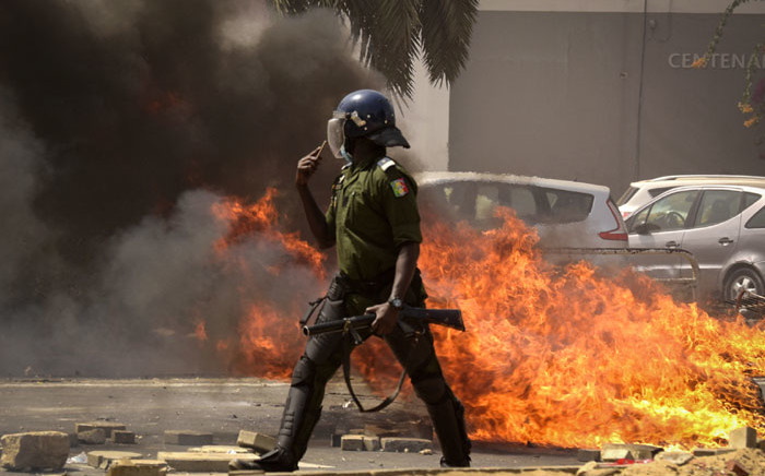 A Senegalese gendarme patrols and clears the streets of Dakar after supporters of Senegal's opposition leader Ousmane Sonko gathered and violent protests broke out in the capital, on 3 March 2021. Picture: AFP