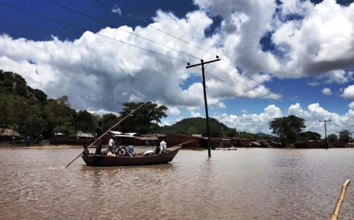 Residents of Phaloni are forced to navigate what was once a soccer pitch by boat on 22 January,2015 after the Sombani River flooded due to heavy rains. Picture: Aletta Gardner/EWN.