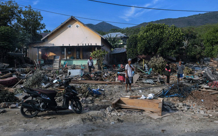 Residents sift through debris along a coastal area in Palu, Indonesia's Central Sulawesi on 2 October 2018, after an earthquake and tsunami hit the area on 28 September 2018. Picture: AFP.