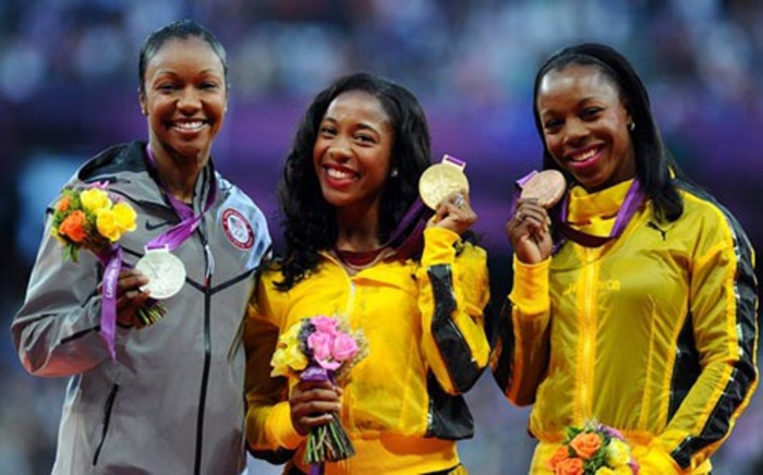 (L-R) Silver medalist Carmelita Jeter of the US, gold medalist Shelly-Ann Fraser-Pryce of Jamaica and bronze medalist Veronica Campbell-Brown of Jamaica pose on the podium for women's 100m at the London Games. Picture: London2012.com.