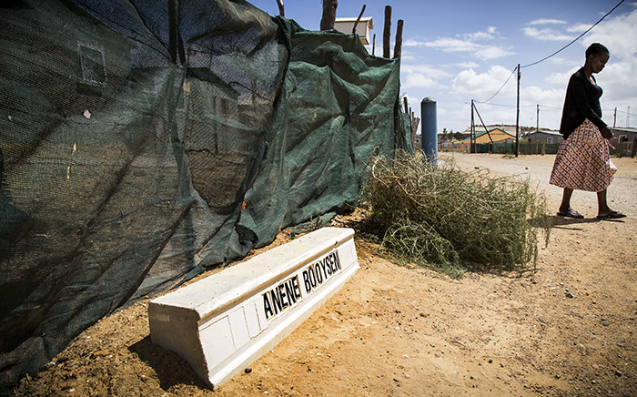A Bredasdorp resident walks past a street dedicated to teenager Anene Booysen, who was murdered in the town in February 2013. Picture: Thomas Holder/EWN