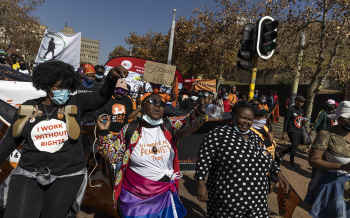Sex workers and supporters shout and sing slogans during a march in solidarity with sex workers set on decriminalising the trade in Johannesburg on May 27, 2021. Picturre: Guillem Sartorio/AFP
