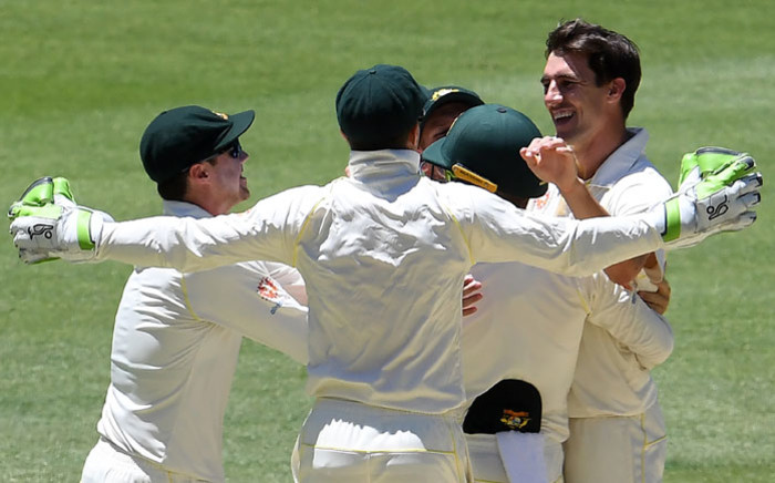 Australia fast bowler Pat Cummins (R) and teammates celebrate the dismissal of India's Jasprit Bumrah during day five of the second Test between Australia and India in Perth on 18 December 2018. Picture: AFP