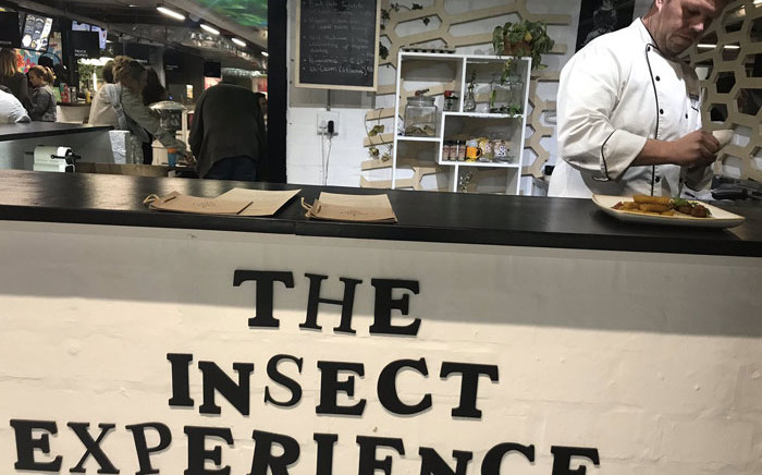 Chef Mario Barnard (right) prepares insect delicacies for customers at The Insect Experience pop-up restaurant in Woodstock. Picture: Monique Mortlock/EWN