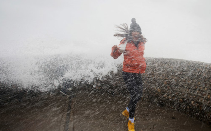 FILE: A woman walks through heavy rains as storm starts to build in the United States. Picture: AFP
