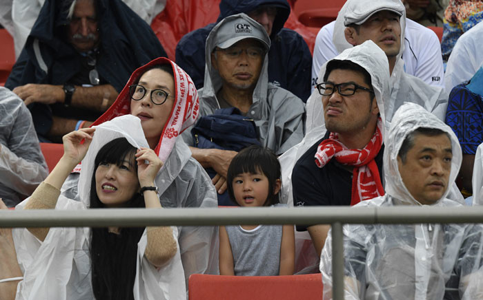FILE: Rugby fans wear raincoats as they sit in the tribunes prior to the Japan 2019 Rugby World Cup Pool D match between Georgia and Fiji at the Hanazono Rugby Stadium in Higashiosaka on 3 October 2019. Picture: AFP.