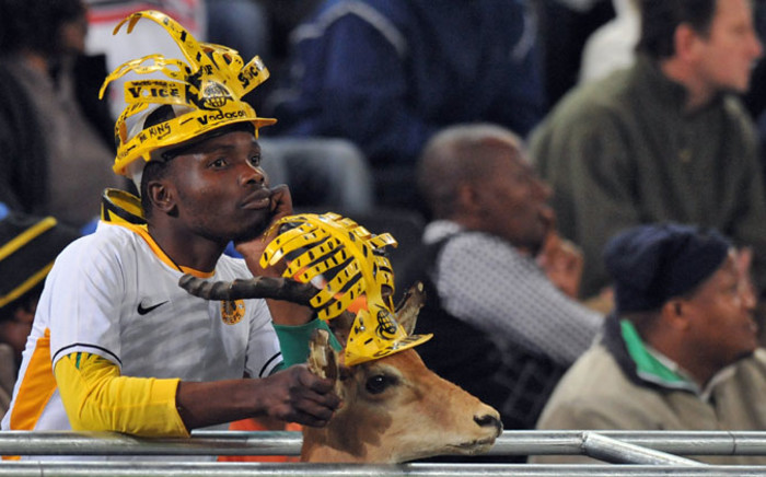 A Kaizer Chiefs' fan looks on next to his antelope during a friendly football match against Manchester City on July 21, 2009, in Durban. Manchester City won 1-0. Picture: AFP.