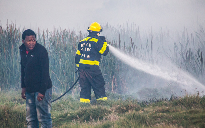 FILE: A firefighter is seen in Masiphumelele following a shack fire in the area. Picture: chrispreenphotography.com