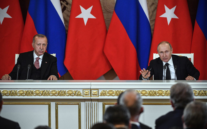 Russian President Vladimir Putin (R) speaks past Turkish President Recep Tayyip Erdogan during their joint press conference at the Kremlin in Moscow on 8 April 2019. Picture: AFP
