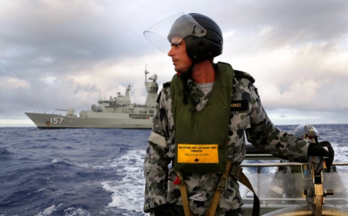 Authorities search for debris on a rigid hull inflatable boat as HMAS Perth searches for missing Malaysia Airlines flight MH370 in the southern Indian Ocean. Picture: AFP.