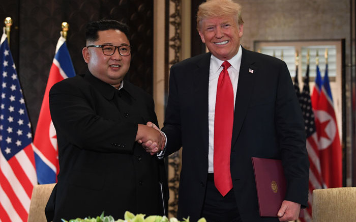 FILE: North Korea's Kim Jong Un shakes hands with US President Donald Trump during their summit meeting in Singapore on 12 June 2018. Picture: AFP