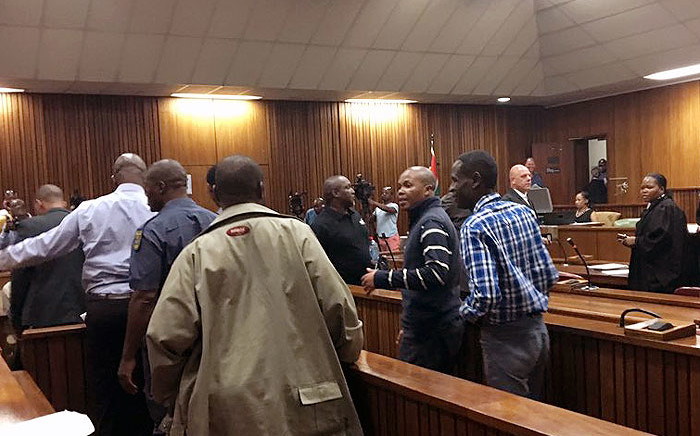 Eight former cops say goodbye to their families after being sentenced to 15 years each on 11 November 2015 for killing Mido Macia. Picture: Masego Rahlaga/EWN