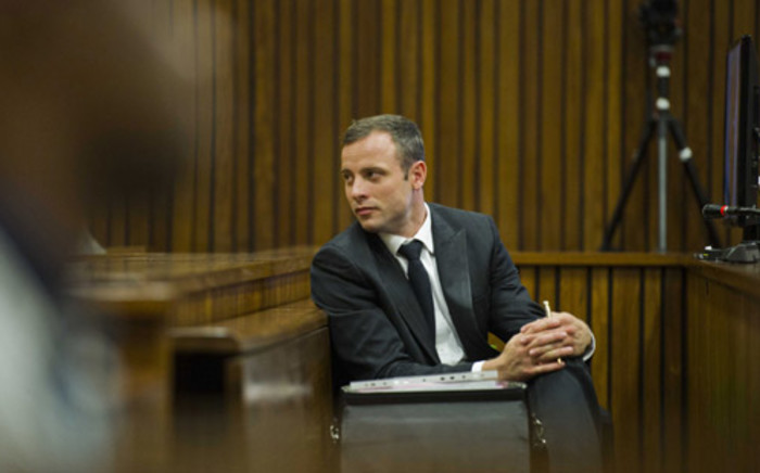 Oscar Pistorius reacts during his murder trial at the High Court in Pretoria on 13 March 2014. Picture: Pool.