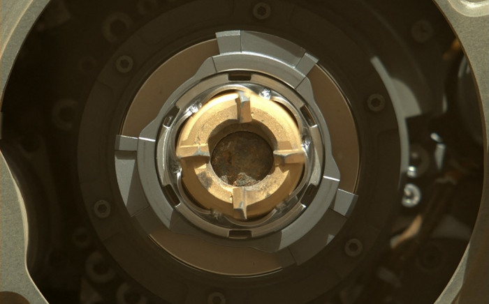 In this image released by NASA Perseverance rover shows a sample tube with its cored-rock contents inside, the bronze-colored outer-ring is the coring bit, the lighter-colored inner-ring is the open end of the tube, and inside is a rock core sample slightly thicker than a pencil, 1 September 2021. Picture: Handout/AFP/NASA