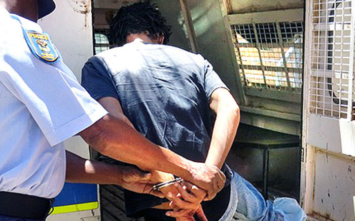 The suspect accused of raping a six-week-old baby in Galeshewe, Northern Cape is put into a police van. Picture: Supplied.