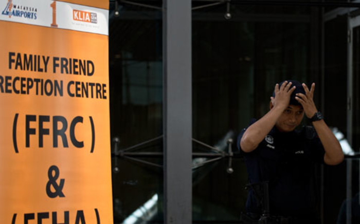 A Malaysian policeman stands guard outside a reception centre for family and friends at the Kuala Lumpur International Airport on 8 March 2014. Picture: AFP.