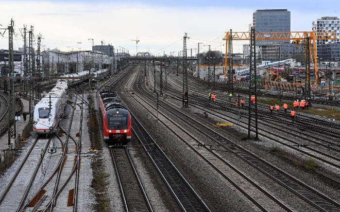 Trains stand on the rails as workers check the tracks after a bomb explosion close to the main railway station in Munich, southern Germany, on 1 December 2021. According to media reports, four persons were injured, one of them seriously, when a World War II bomb exploded as works were under way at a construction site close to the railway station. PICTURE: AFP