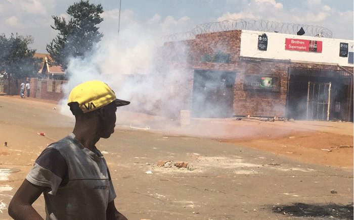 FILE: Police fire a teargas canister to disperse crowd in front of the shops during the Bekkersdal protest on 6 March 2015. Picture: Govan Whittles/EWN.