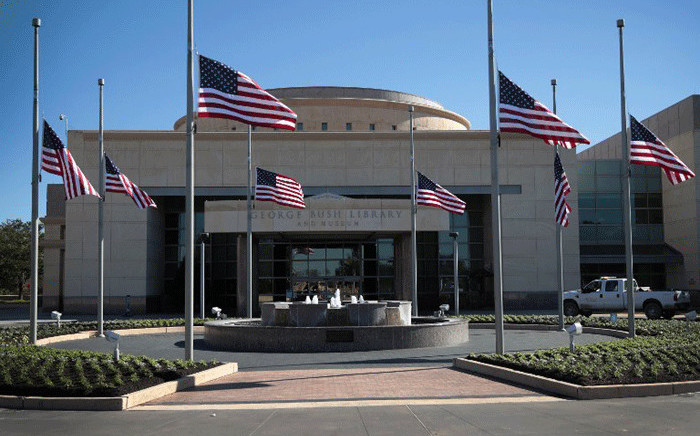 Flags fly at half-mast in front of the George H.W. Bush Presidential Library Center on the campus of Texas A&M University on 2 December, 2018 in College Station, Texas. Bush, who died on 30 November, will be buried next to his wife Barbara near the library on Thursday. Picture: AFP.