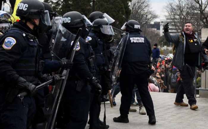 Trump supporters face off with police and security forces in front of the US Capitol in Washington DC on 6 January 2021. Donald Trump's supporters stormed a session of Congress to certify Joe Biden's election win. Picture: AFP.