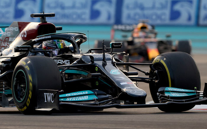 Mercedes driver Lewis Hamilton drives ahead of Red Bull driver Max Verstappen at the Yas Marina Circuit during the Abu Dhabi Formula One Grand Prix on 12 December 2021. Picture: Giuseppe CACACE/AFP