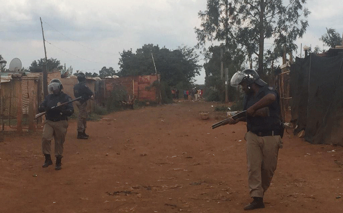 Police have once again used tear gas and rubber bullets in Thembelihle where a small group of people have tried to burn down the house of a man alleged to have shot at protestors on 25 February 2015. Picture: Govan Whittles/EWN.	