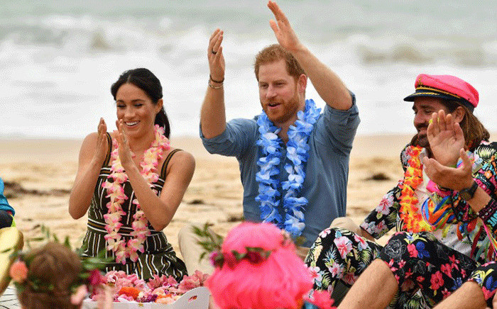 Britain's Prince Harry and his wife Meghan, Duchess of Sussex attend a "Fluro Friday" session run by OneWave, a local surfing community group who raise awareness for mental health and wellbeing, at Sydney's iconic Bondi Beach on 19 October, 2018. Picture: AFP.