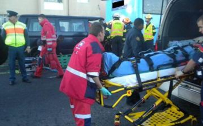 Emergency personnel attend to the victims of a collision between a bus and a taxi on Koeberg Road in the Western Cape.