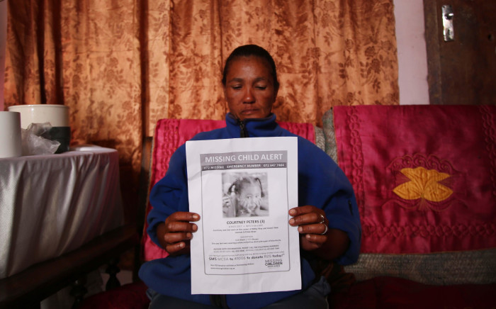  Juanita Pieters hold up a flyer with her daughter, Courtney Pieters picture on it. Picture: Bertram Malgas/EWN.