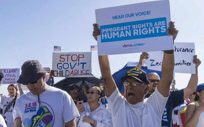 Activists shout chants during the "End Family Detention," event held at the Tornillo Port of Entry in Tornillo, Texas on 24 June 2018. Picture: AFP.