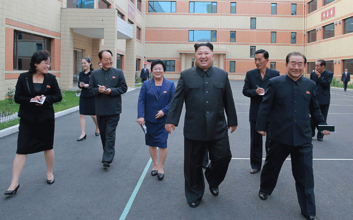 This undated picture released from North Korea's official Korean Central News Agency (KCNA) on October 19, 2017 shows North Korean leader Kim Jong-Un (C) visiting the Ryuwon Footwear Factory in Pyongyang. Picture: AFP VIA KNS.