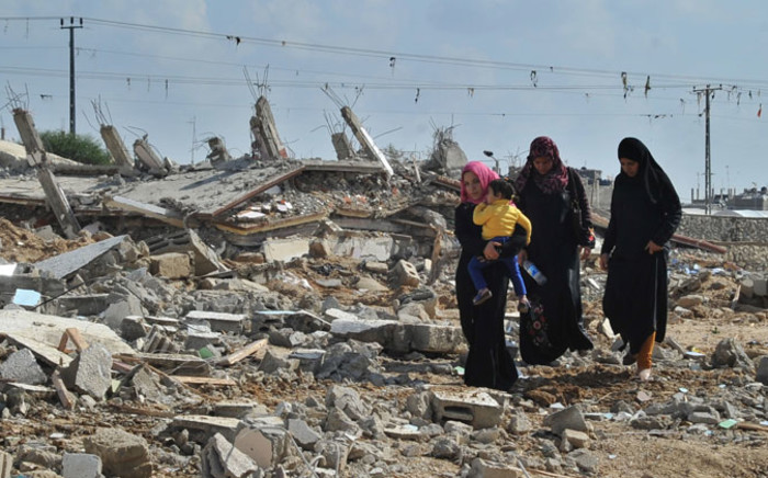 Egyptian women walk through rubble of houses destroyed by Egyptian security forces near the border with the Gaza Strip, in Rafah, Egypt, on 5 November 2014. Egyptian authorities have evacuated and demolished over 800 houses belonging to 1,165 families in North Sinai along the border with the Palestinian Gaza Strip in order to create a security buffer zone. Picture: EPA.