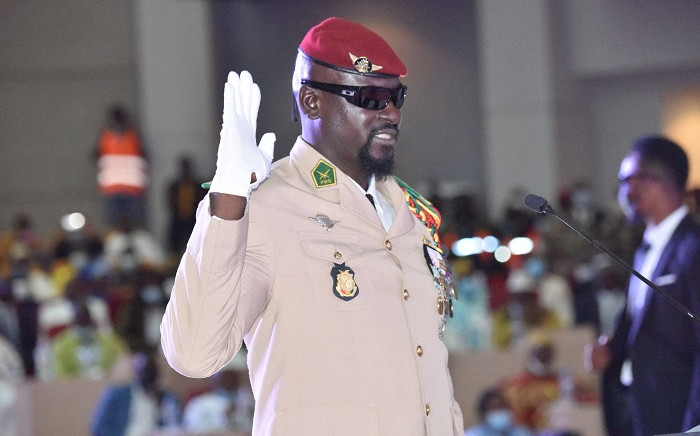 Guinea junta leader Colonel Mamady Doumbouya, raises his hand at his swearing-in ceremony as president of country transition on 1 October 2021 in Conakry. The head of the junta in Guinea, Colonel Mamady Doumbouya, was sworn in on Friday as president of this West African country for a period of transition of still unknown duration and content. Picture: Cellou Binani/AFP