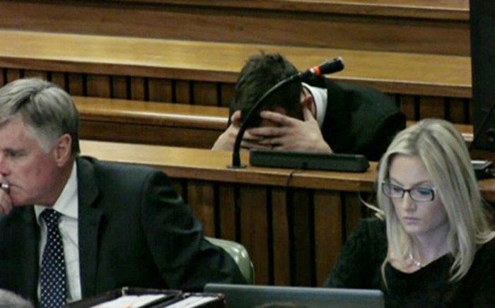 Oscar Pistorius reacts at the High Court in Pretoria during his trial. Picture: Pool.