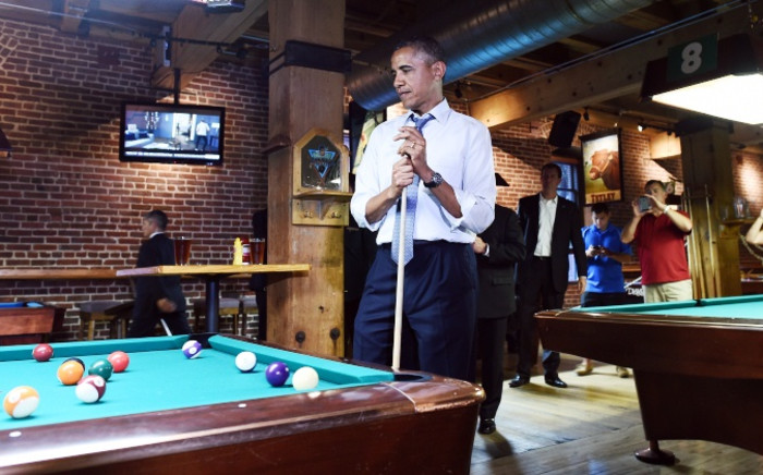 US President Barack Obama playing a game of pool at a pub in Denver, Colorado, on 8 July. Picture: AFP.