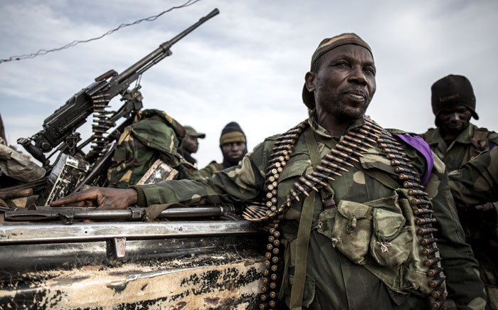 FILE: Soldiers of the Armed Forces of the Democratic Republic of the Congo (FARDC) sit in a truck bed in a base on 3 July 2019 in Djugu, eastern DR Congo. Picture: AFP
