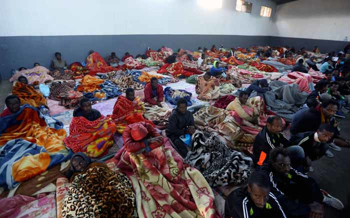 FILE: African migrants sitting in a shelter at the Tariq Al-Matar migrant detention centre on the outskirts of the Libyan capital Tripoli. Picture: AFP