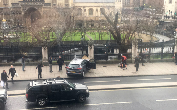 A picture obtained from the Twitter account of James West shows the car, which Khalid Masood ploughed through a crowd of people, on the sidewalk in front of the Palace of Westminster which houses the Houses of Parliament in central London. Picture: AFP/James West.