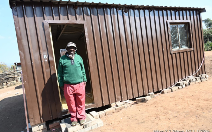Man stands in front of housing unit in Talana, Tzaneen. Image: Limpopo Gov/Elvis Tshikhudo