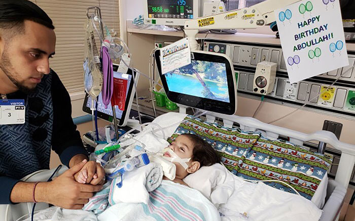 This photo courtesy of the Council on American-Islamic relations in Sacramento shows the young Abdullah Hassan on life support at UCSF Benioff Children's Hospital in Oakland on 16 December 2018 with his father, Ali. Picture: AFP