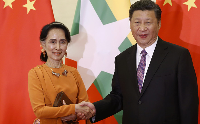 Myanmar State Counsellor Aung San Suu Kyi (L) shakes hands with Chinese President Xi Jinping during a meeting at the Great Hall of the People in Beijing on 16 May, 2017. Picture: AFP.