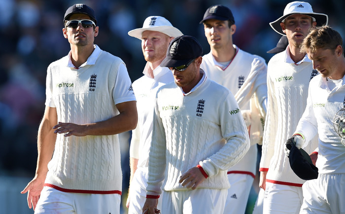 England’s Alastair Cook (L) leads his players back to the pavilion as play finishes on the second day of the third Ashes cricket test match between England and Australia at Edgbaston in Birmingham, central England, on 30 July, 2015. Picture: AFP.