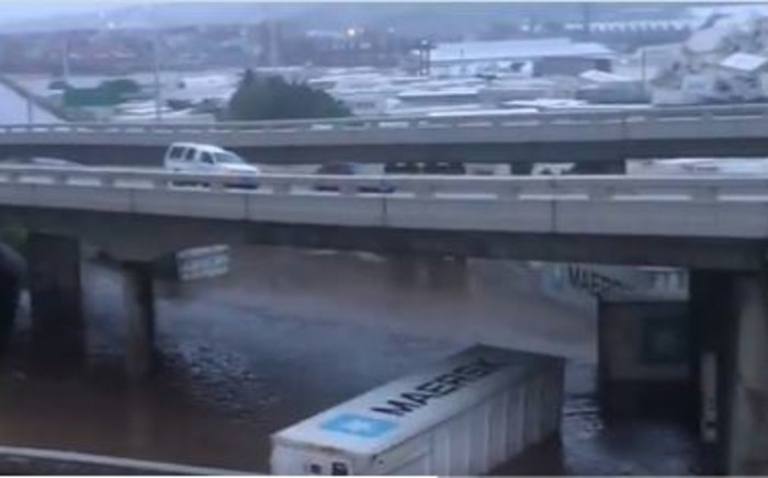 Screengrab of containers drifting in floodwaters in KZN from video posted by Eyewitness News @ewnreporter