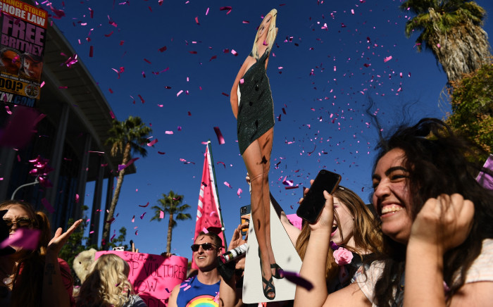 Supporters of the FreeBritney movement celebrate following a court decision ending her conservatorship outside the Stanley Mosk courthouse in Los Angeles on 12 November 2021. Picture: AFP