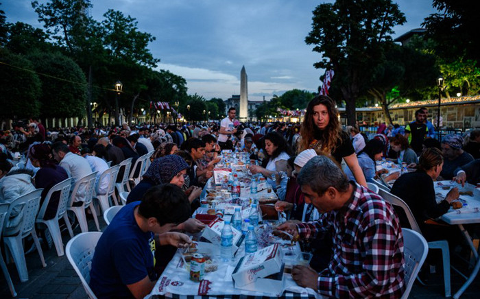 Thousands of Turkish people break their fasting on June 6, 2016 at the Blue Mosque square in Istanbul, during the first day of the holy month of Ramadan. More than a billion Muslims observed the start of Ramadan on May 6 but in the besieged cities of Syria and Iraq residents struggled to mark the holy month. Marking the divine revelation received by Prophet Mohammed, the month sees Muslim faithful abstain from eating, drinking, smoking and having sex from dawn to dusk. They break the fast with a meal known as iftar and before dawn have a second opportunity to eat and drink during suhur. The month is followed by the Eid al-Fitr festival. Picture: AFP.