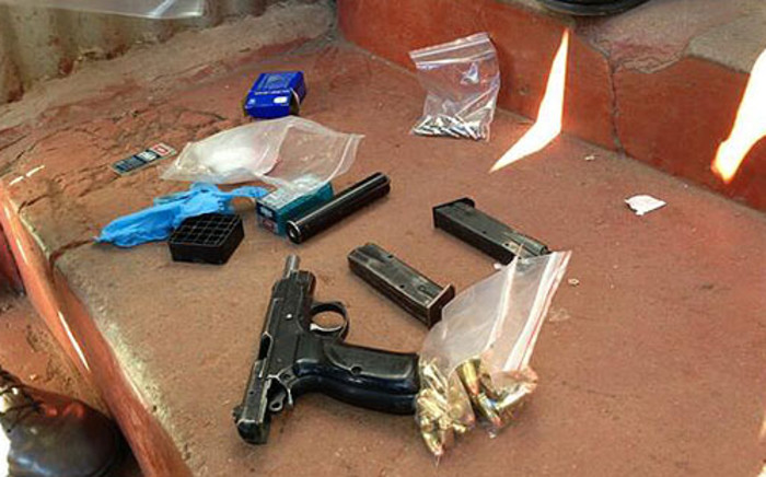 A 9mm pistol, ammunition and an AK47 rifle were recovered during a raid in Alexandra. Picture: Lesego Ngobeni/EWN