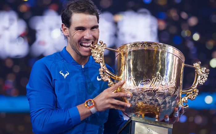 Rafael Nadal of Spain holds the trophy after winning the men's singles final match against Nick Kyrgios of Australia at the China Open tennis tournament in Beijing on 8 October, 2017. Picture: AFP.